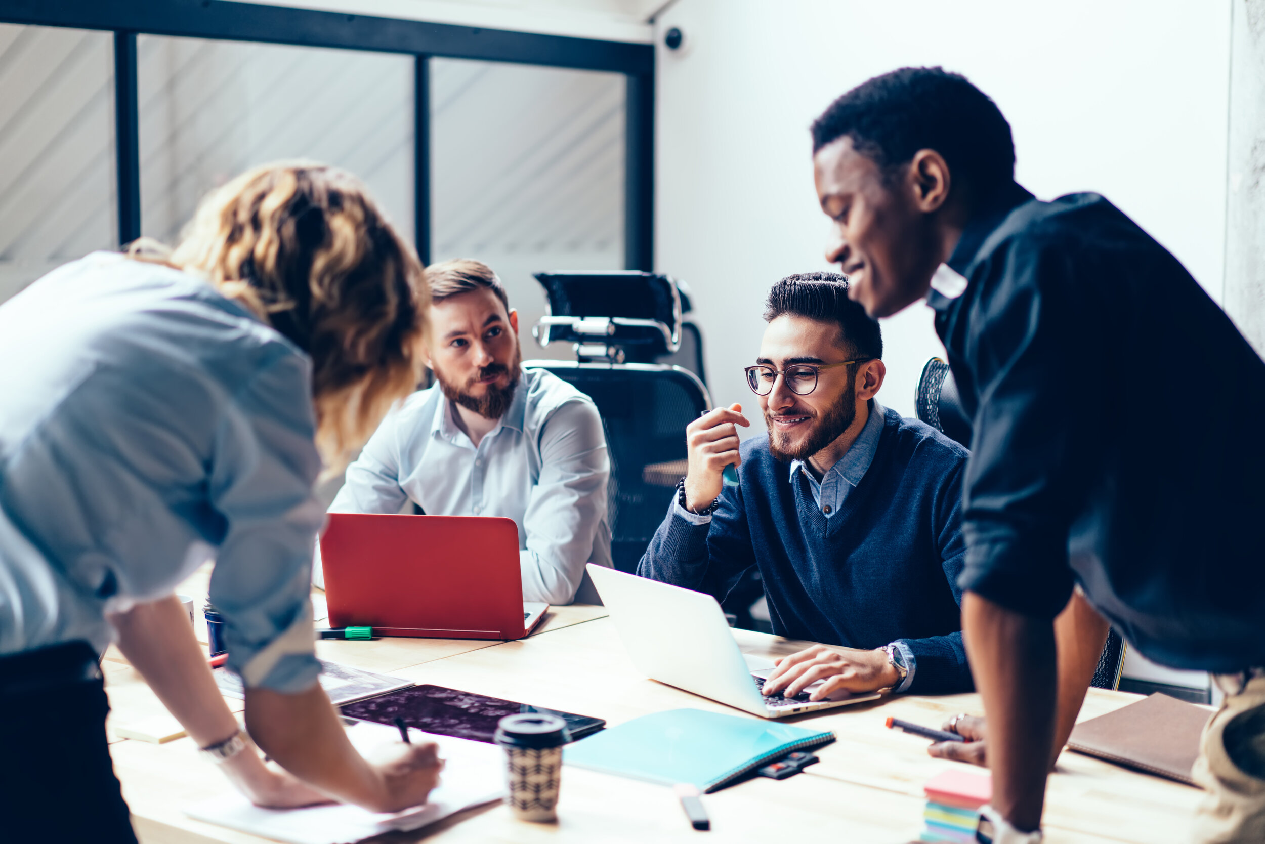 people around a table working and discussing